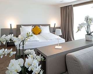 Stylish bedroom with orchids and contemporary furnishings.